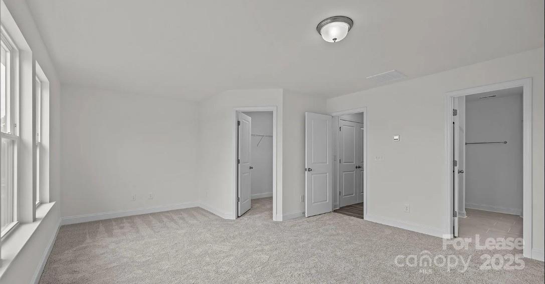 2035 Near Pt Road Charlotte, NC 28208 - Photo 8 of 13 an empty room with windows and closet