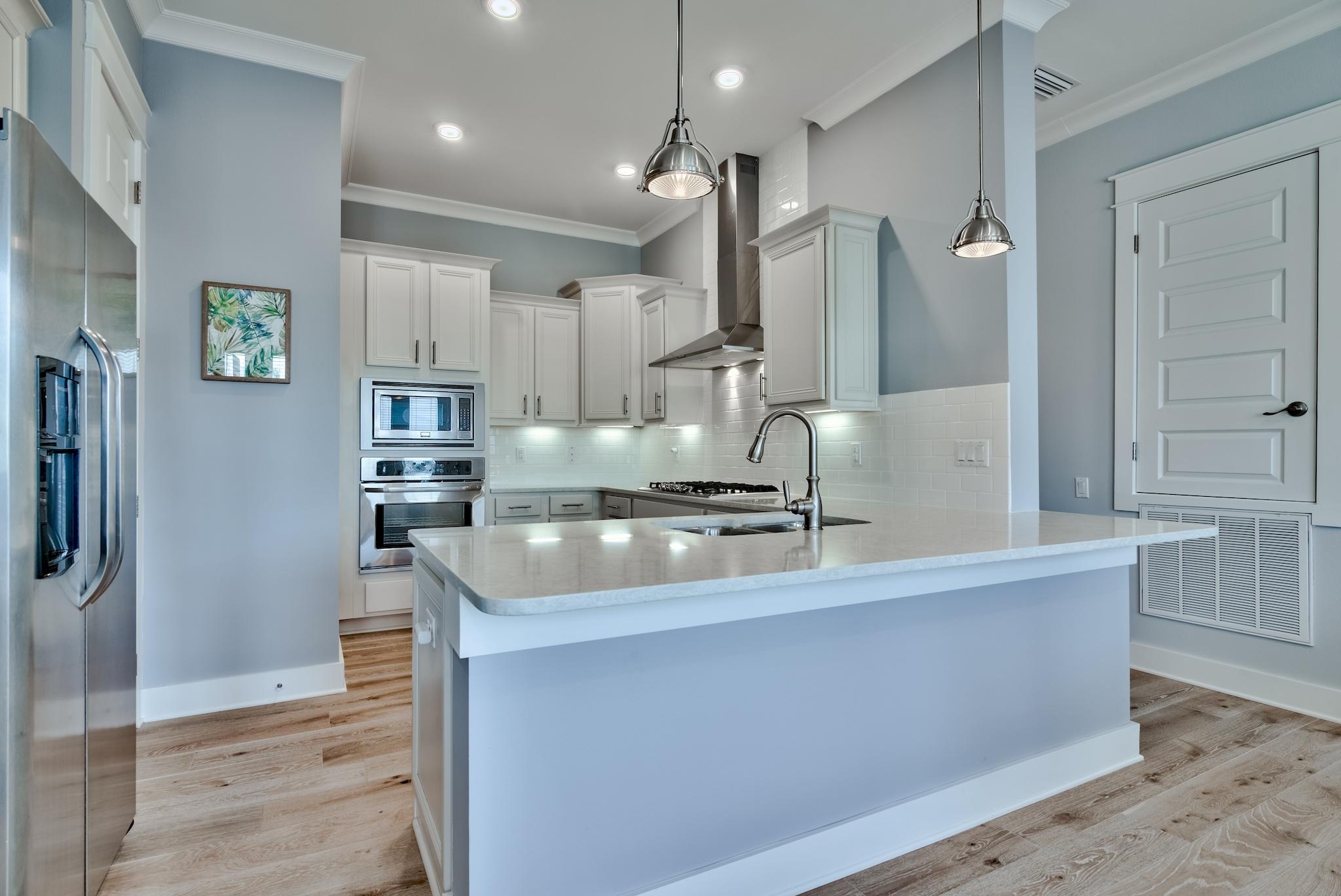 94 Milestone Drive Inlet Beach, Unit C Inlet Beach, FL 32461 - Photo 6 of 41 a kitchen with stainless steel appliances granite countertop a sink a stove and a refrigerator