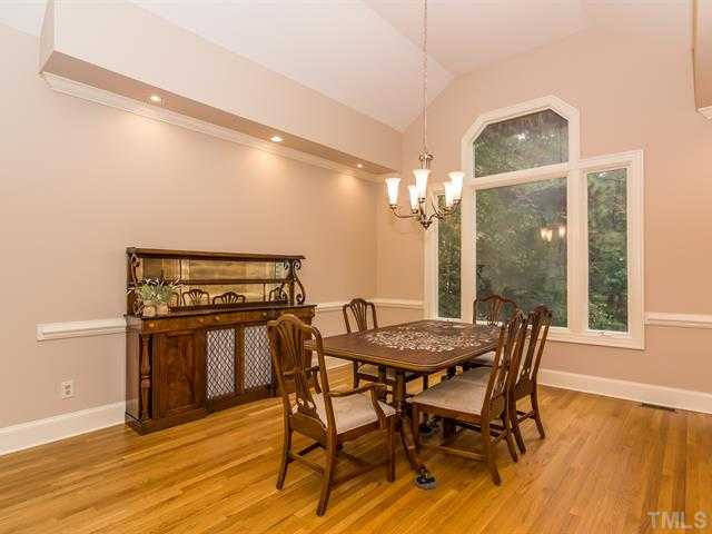 10108 Old Warden Road Raleigh, NC 27615 - Photo 4 of 25 The dining room features newly refinished wood floors, new lighting, chair rail molding and crown molding! Dining Room