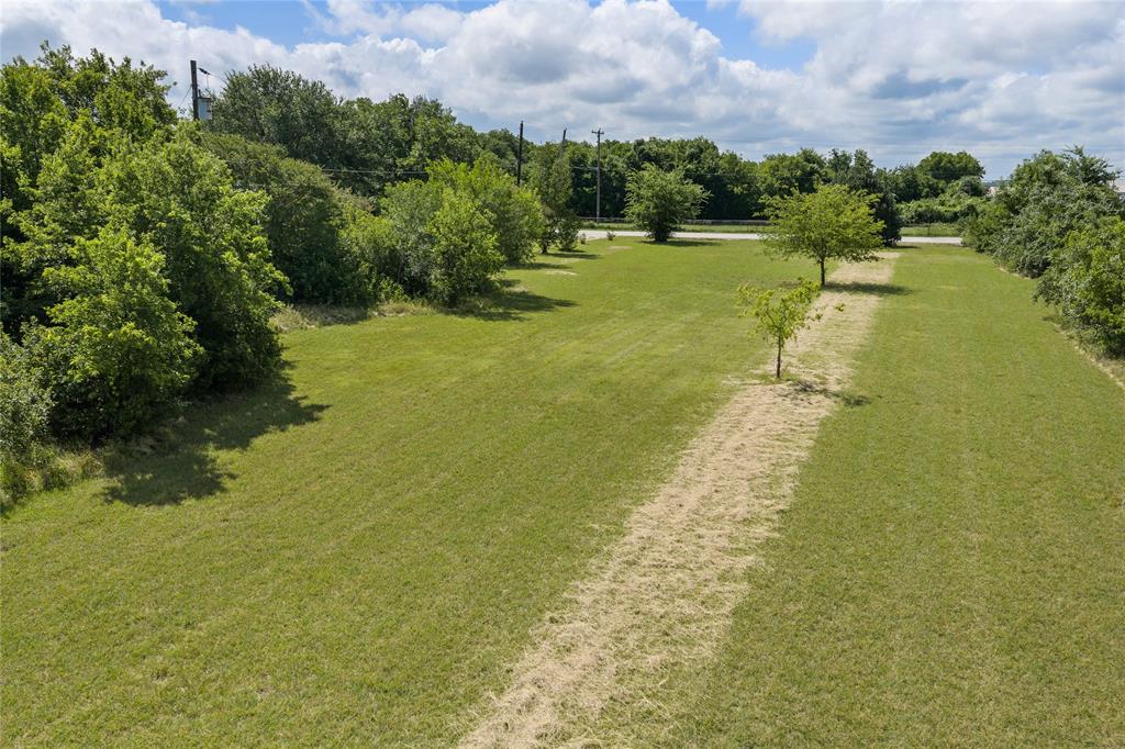 440 Williams Road Lorena, TX 76655 - Photo 10 of 19 Expansive grassy lot featuring a central mown path, scattered mature trees, and a perimeter of dense foliage