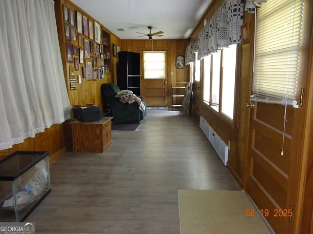 a living room with furniture and a floor to ceiling window