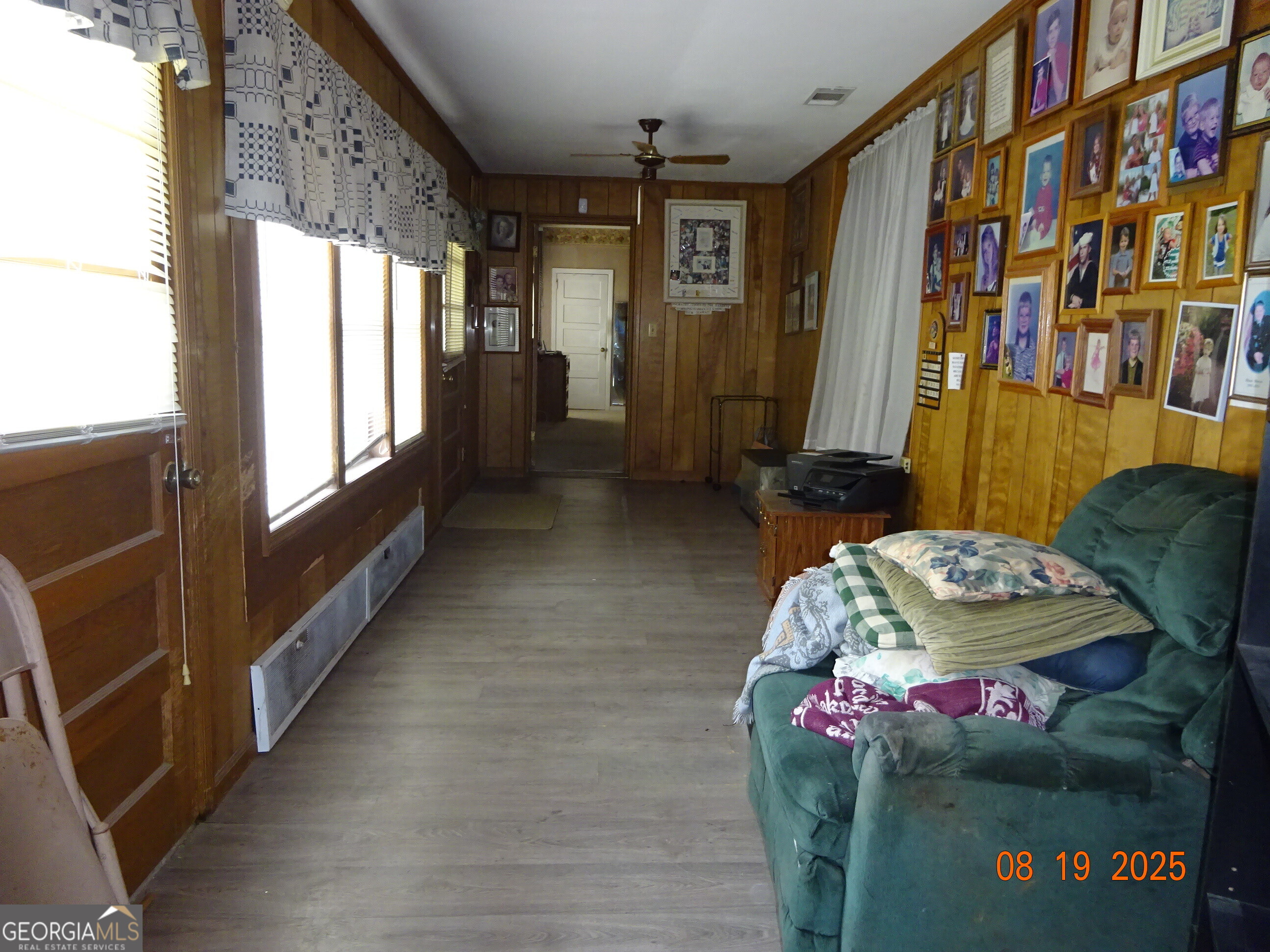 6 North Spring Street Claxton, GA 30417 - Photo 18 of 26 a living room with furniture and a floor to ceiling window