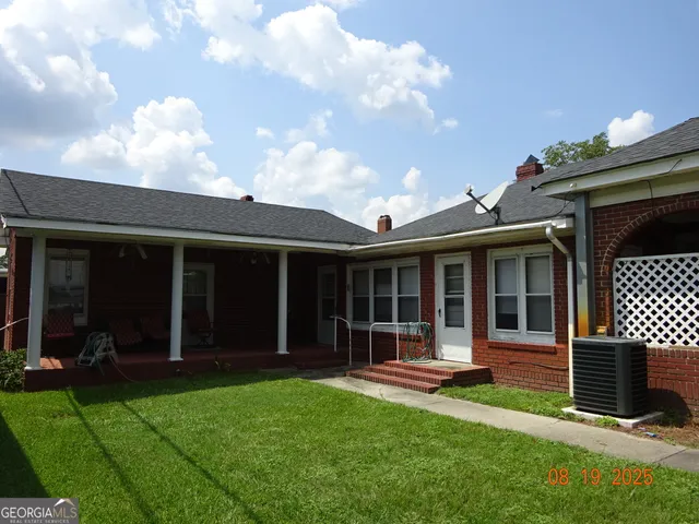 a view of a house with garden and porch