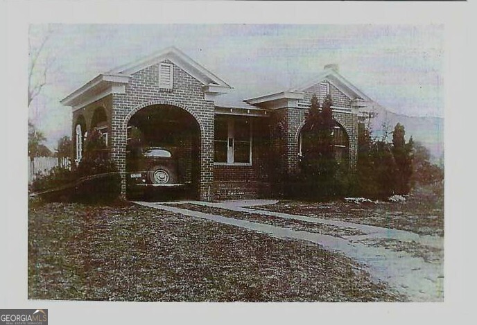 6 North Spring Street Claxton, GA 30417 - Photo 26 of 26 a view of a grey house with a snow