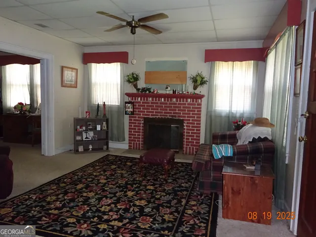 a living room with furniture a window and a fireplace