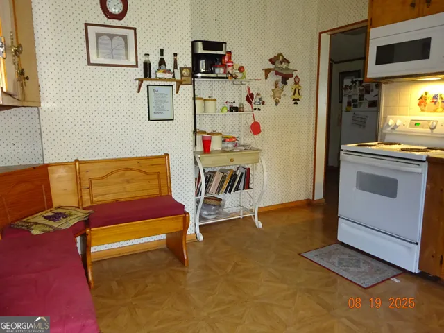 a view of a livingroom with furniture and a flat screen tv