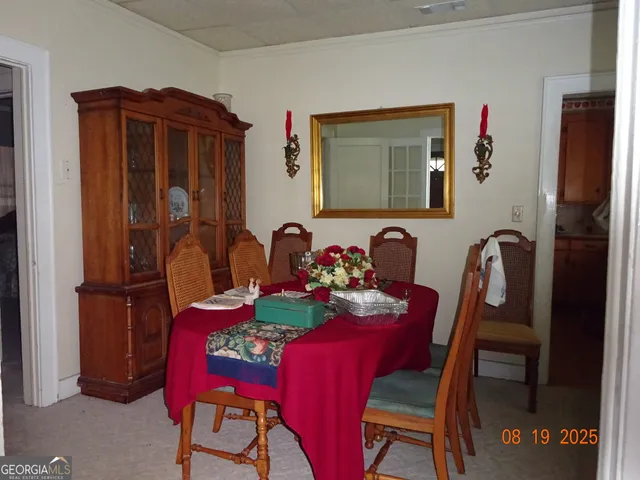 a view of a dining room with furniture and window