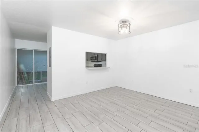 a view of a room with wooden floor and ceiling fan
