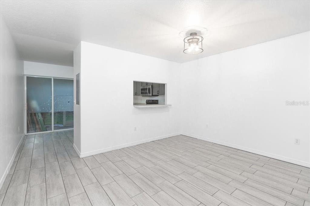 12946 Trade Port Place Riverview, FL 33579 - Photo 11 of 26 a view of a room with wooden floor and ceiling fan