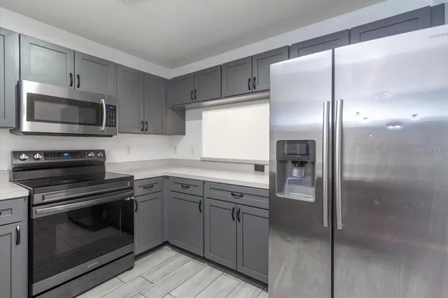 a kitchen with a refrigerator stove and microwave
