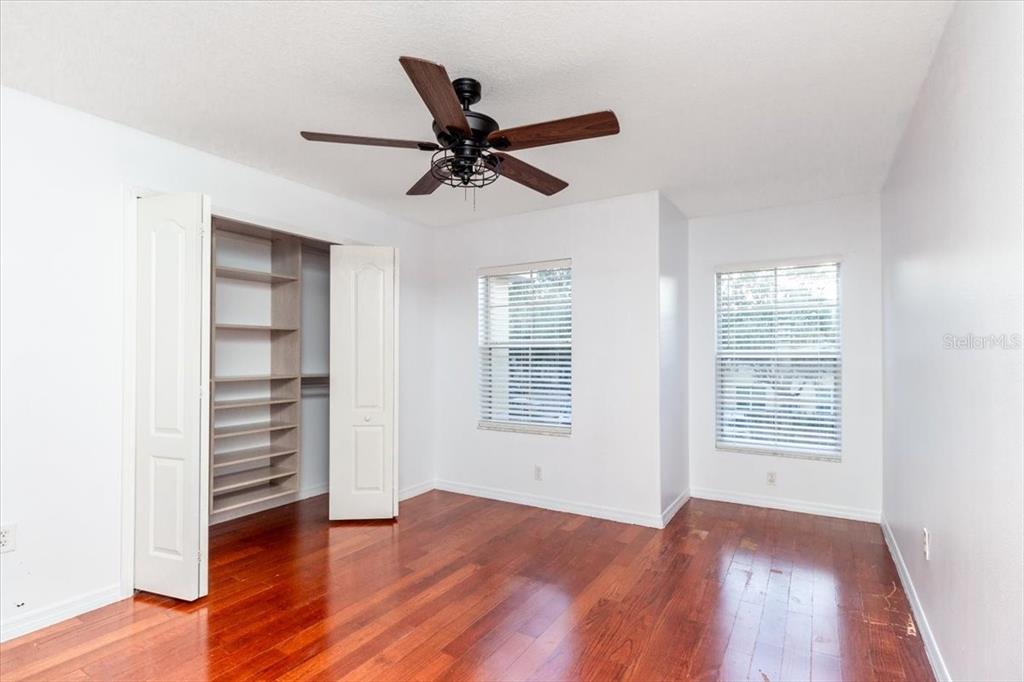 12946 Trade Port Place Riverview, FL 33579 - Photo 18 of 26 a view of an empty room with a window and wooden floor