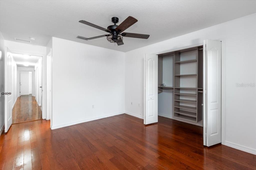12946 Trade Port Place Riverview, FL 33579 - Photo 19 of 26 a view of a livingroom with wooden floor and a ceiling fan