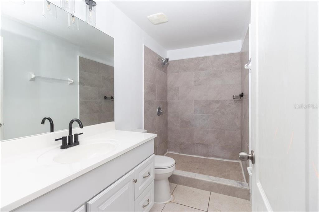 12946 Trade Port Place Riverview, FL 33579 - Photo 20 of 26 a bathroom with a sink a toilet and shower