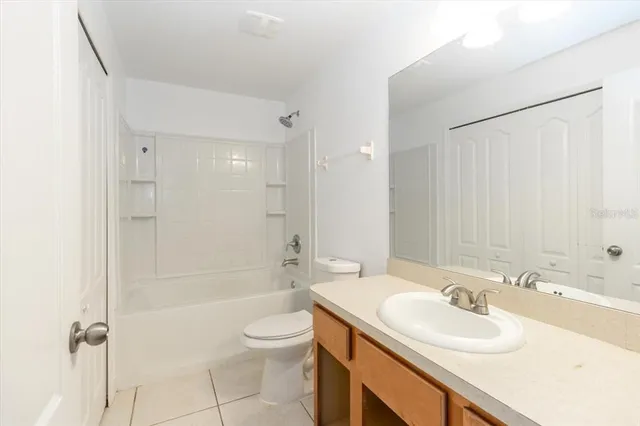 a bathroom with a sink toilet tub and shower