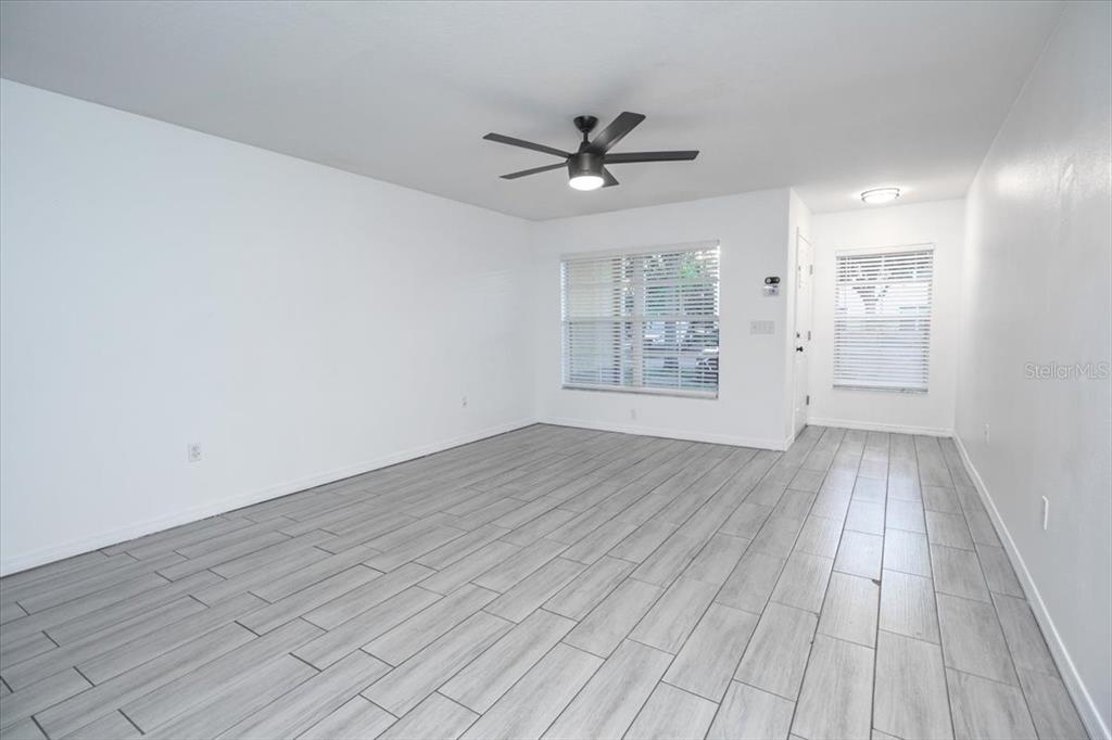 12946 Trade Port Place Riverview, FL 33579 - Photo 6 of 26 wooden floor in an empty room with a window