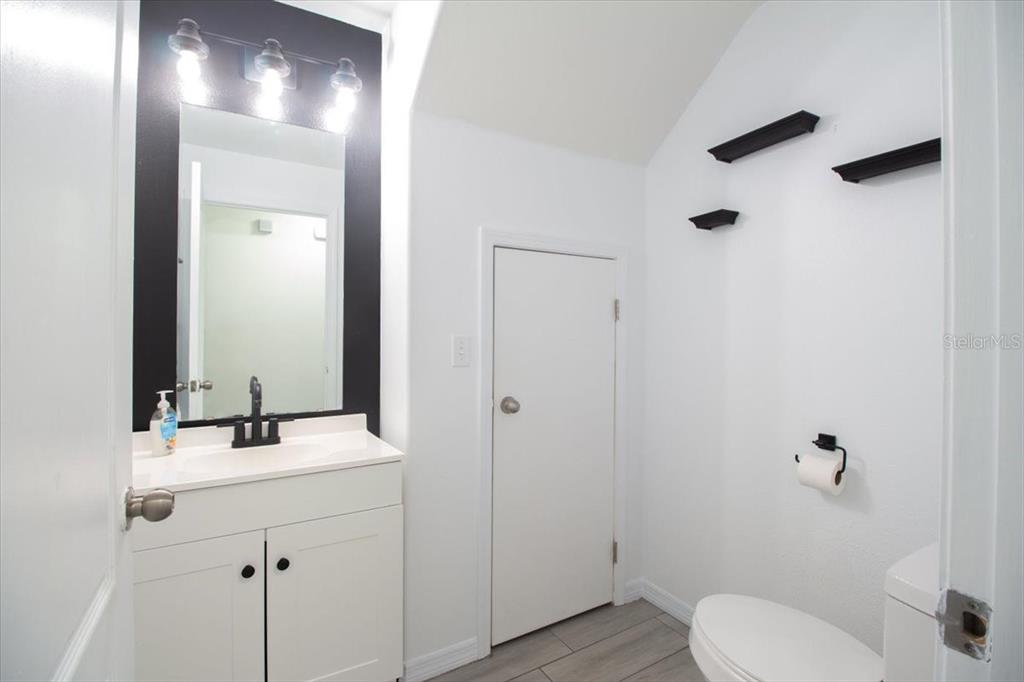12946 Trade Port Place Riverview, FL 33579 - Photo 10 of 26 a bathroom with a toilet a sink and mirror