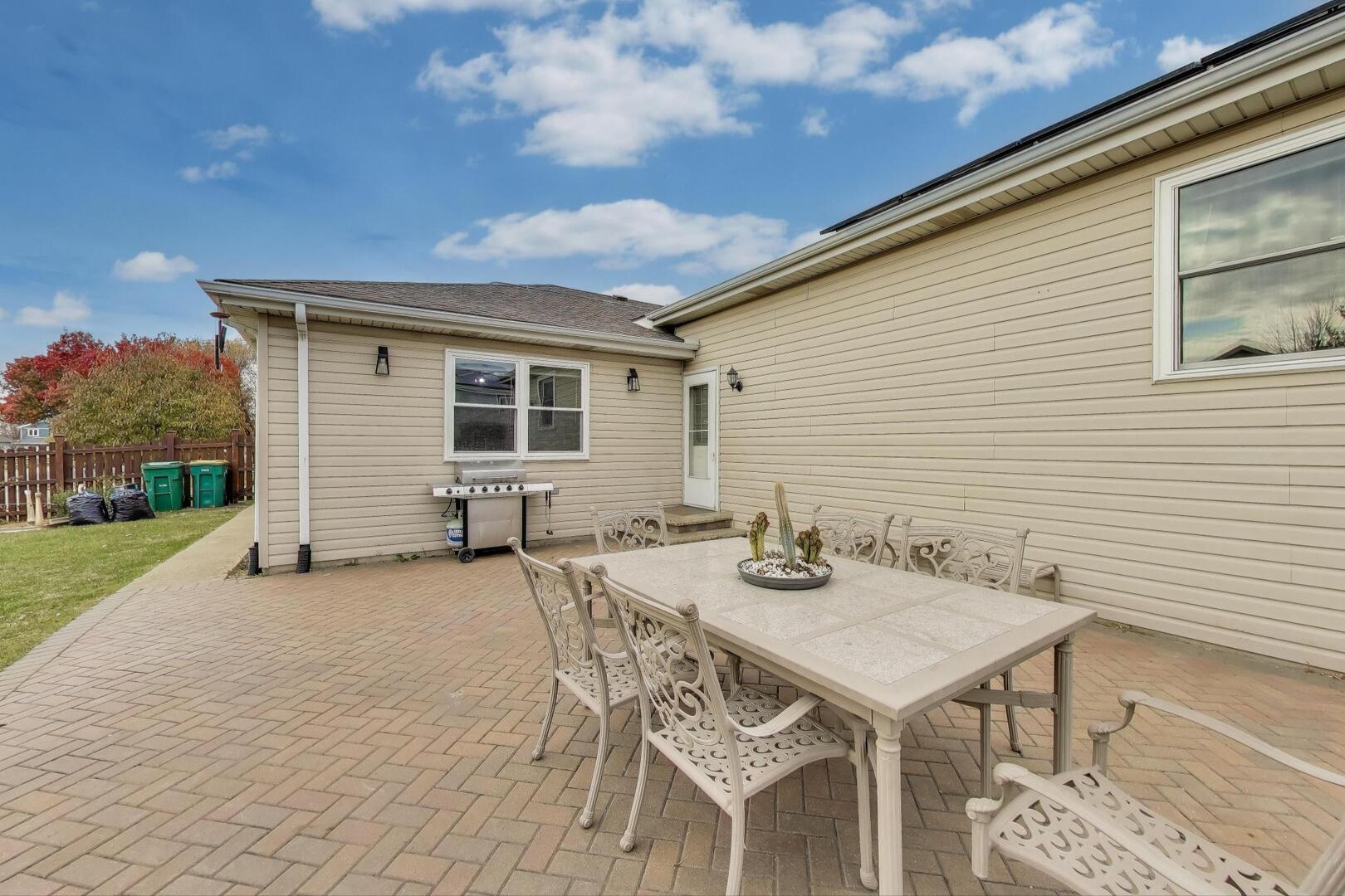635 Huron Drive Romeoville, IL 60446 - Photo 26 of 32 a view of a patio with table and chairs and garden