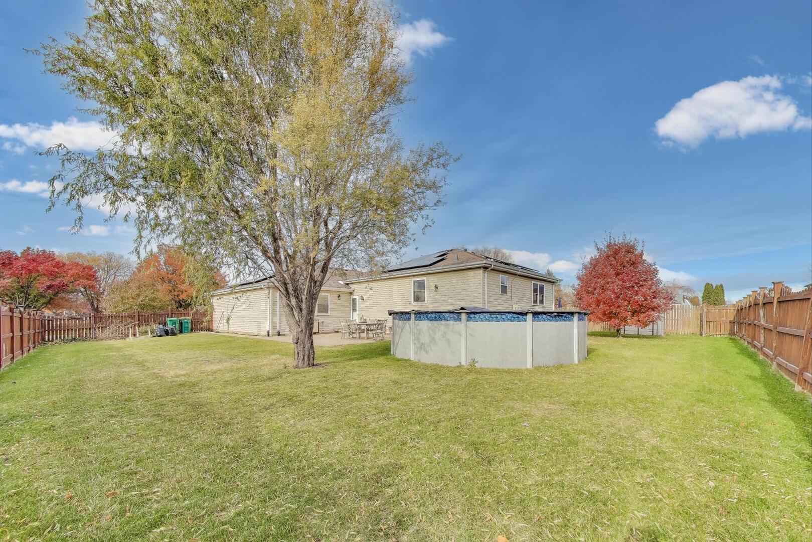 635 Huron Drive Romeoville, IL 60446 - Photo 28 of 32 a white house with a big yard and large trees
