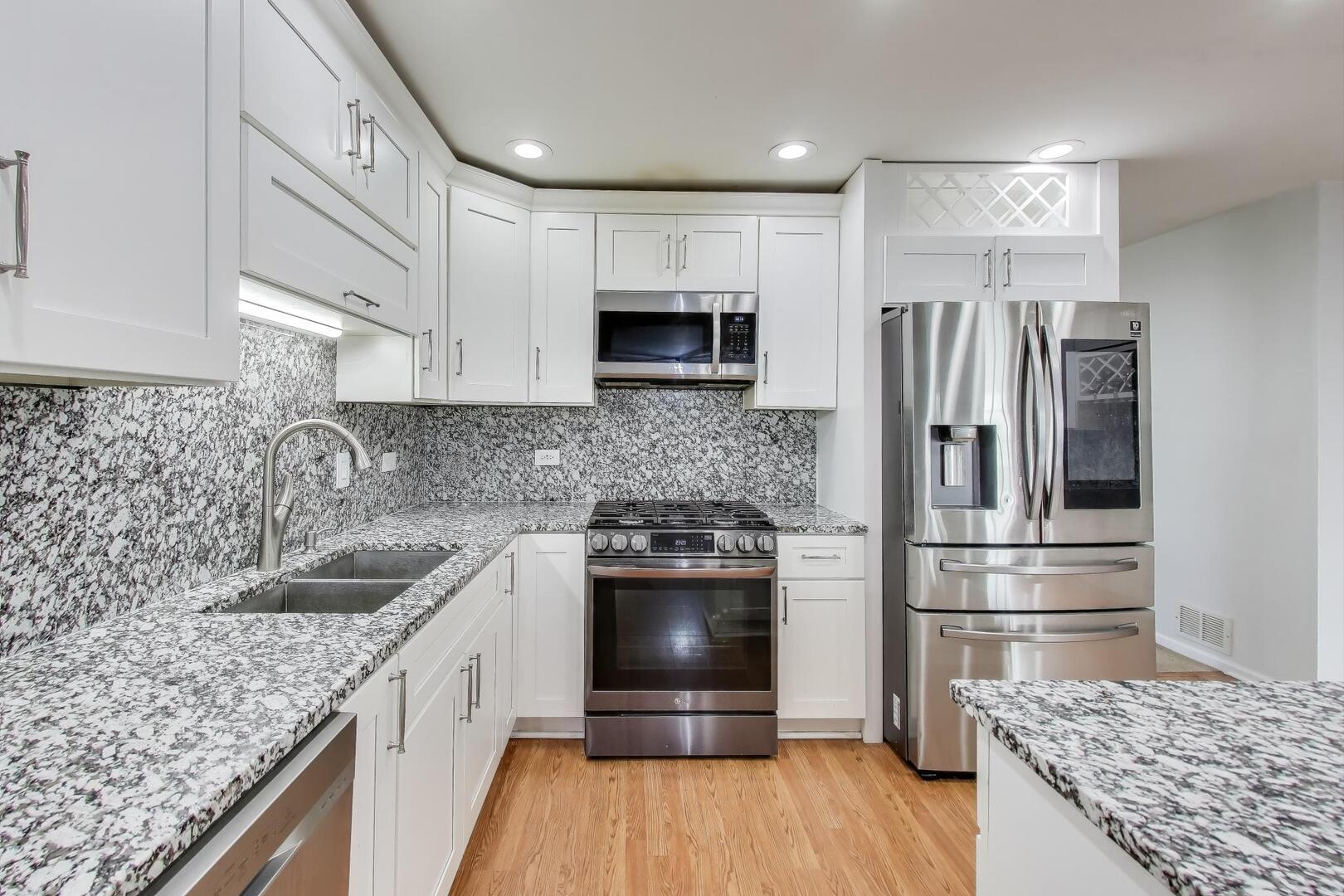 635 Huron Drive Romeoville, IL 60446 - Photo 9 of 32 a kitchen with stainless steel appliances granite countertop a sink stove and refrigerator