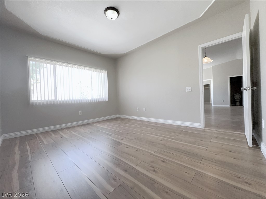 8725 West Flamingo Road, Unit 208 Las Vegas, NV 89147 - Photo 10 of 16 This airy room offers light wood flooring, a window, and a vaulted ceiling.