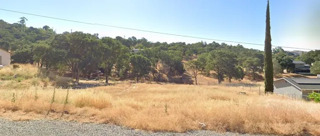 a view of a yard covered with snow on the road