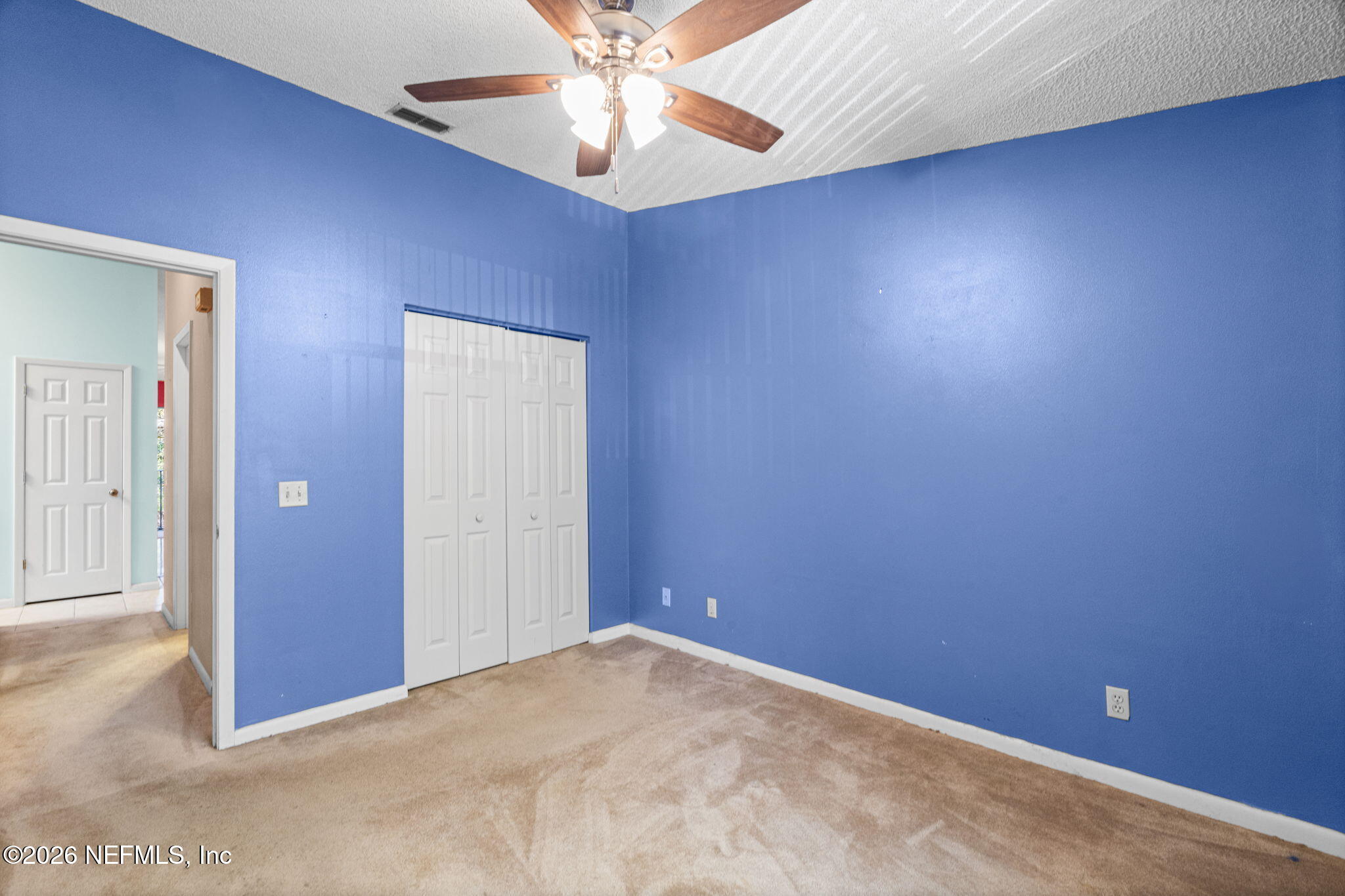36 Navarra Court St. Augustine, FL 32086 - Photo 23 of 42 an empty room with a chandelier fan and windows