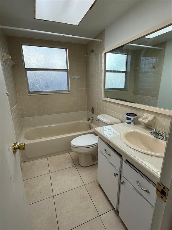 9007 Spring Hill Drive Spring Hill, FL 34608 - Photo 11 of 12 a bathroom with a granite countertop sink a toilet and mirror