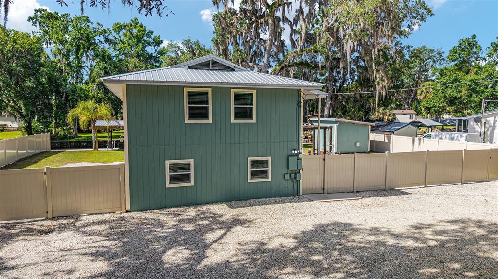 24628 Fox Road Astor, FL 32102 - Photo 20 of 96 a front view of a house with a yard and garage