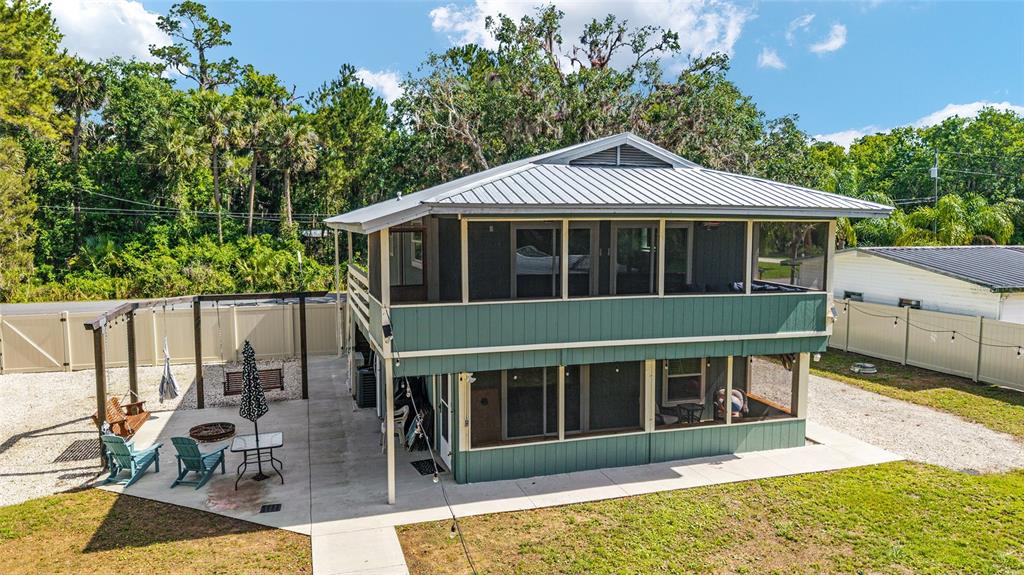24628 Fox Road Astor, FL 32102 - Photo 2 of 96 a view of a house with a large window and wooden fence