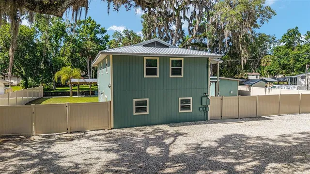 a view of swimming pool with a table and chairs under an umbrella