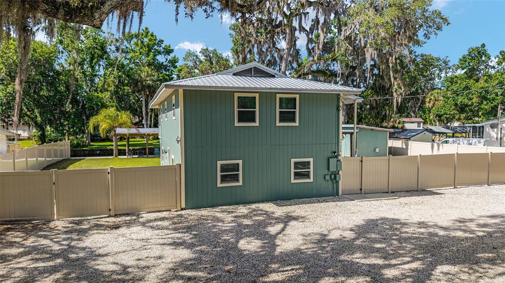 24628 Fox Road Astor, FL 32102 - Photo 21 of 96 a front view of a house with a yard and garage