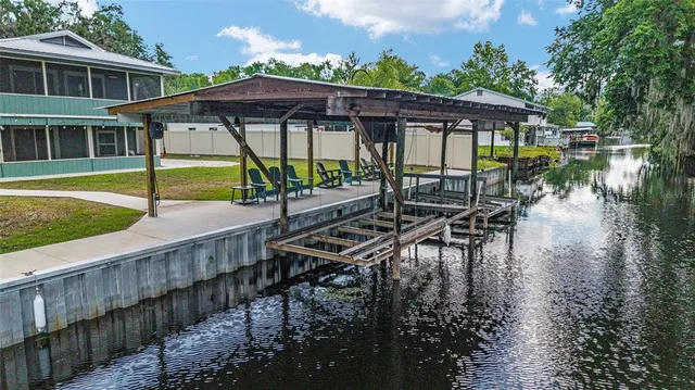 a living room with furniture pool table and a wooden floor