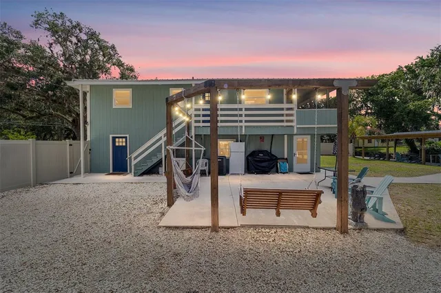 a bedroom with a large bed a chandelier and a window