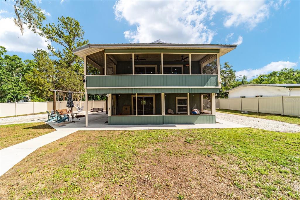 24628 Fox Road Astor, FL 32102 - Photo 33 of 96 a view of a house with swimming pool and sitting area