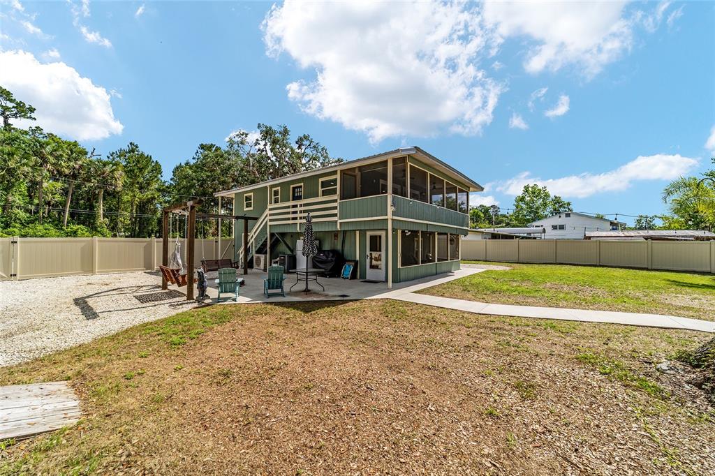 24628 Fox Road Astor, FL 32102 - Photo 38 of 96 a view of a house with a yard and sitting area