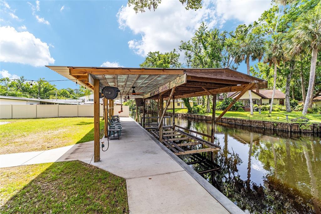 24628 Fox Road Astor, FL 32102 - Photo 41 of 96 a view of swimming pool with a table and chairs under an umbrella
