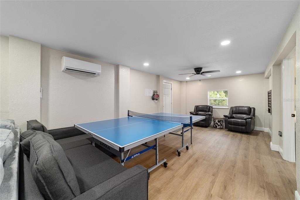 24628 Fox Road Astor, FL 32102 - Photo 56 of 96 a living room with furniture pool table and a wooden floor