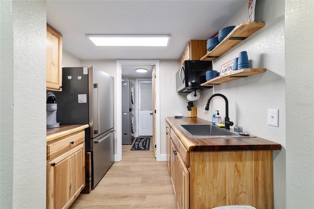 24628 Fox Road Astor, FL 32102 - Photo 60 of 96 a kitchen with stainless steel appliances a sink and a refrigerator