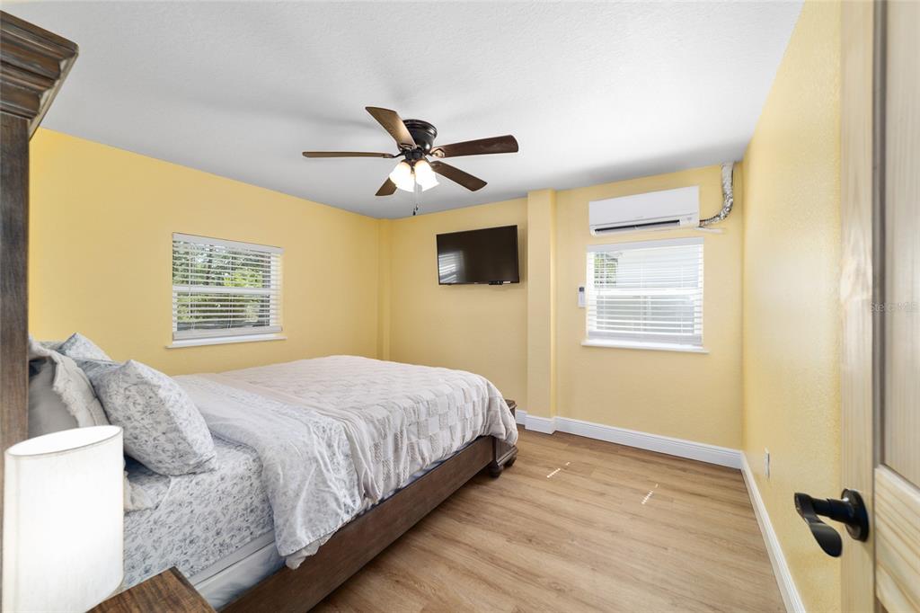 24628 Fox Road Astor, FL 32102 - Photo 70 of 96 a bedroom with a large bed a chandelier and a window