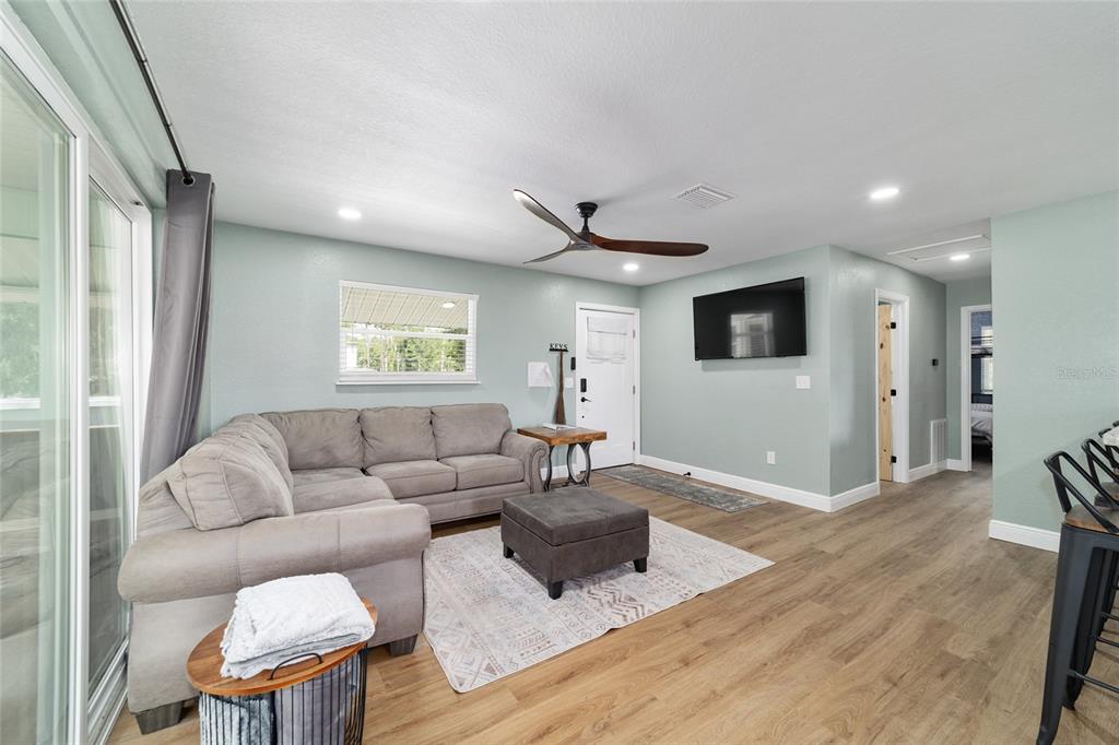 24628 Fox Road Astor, FL 32102 - Photo 80 of 96 a living room with furniture and a wooden floor