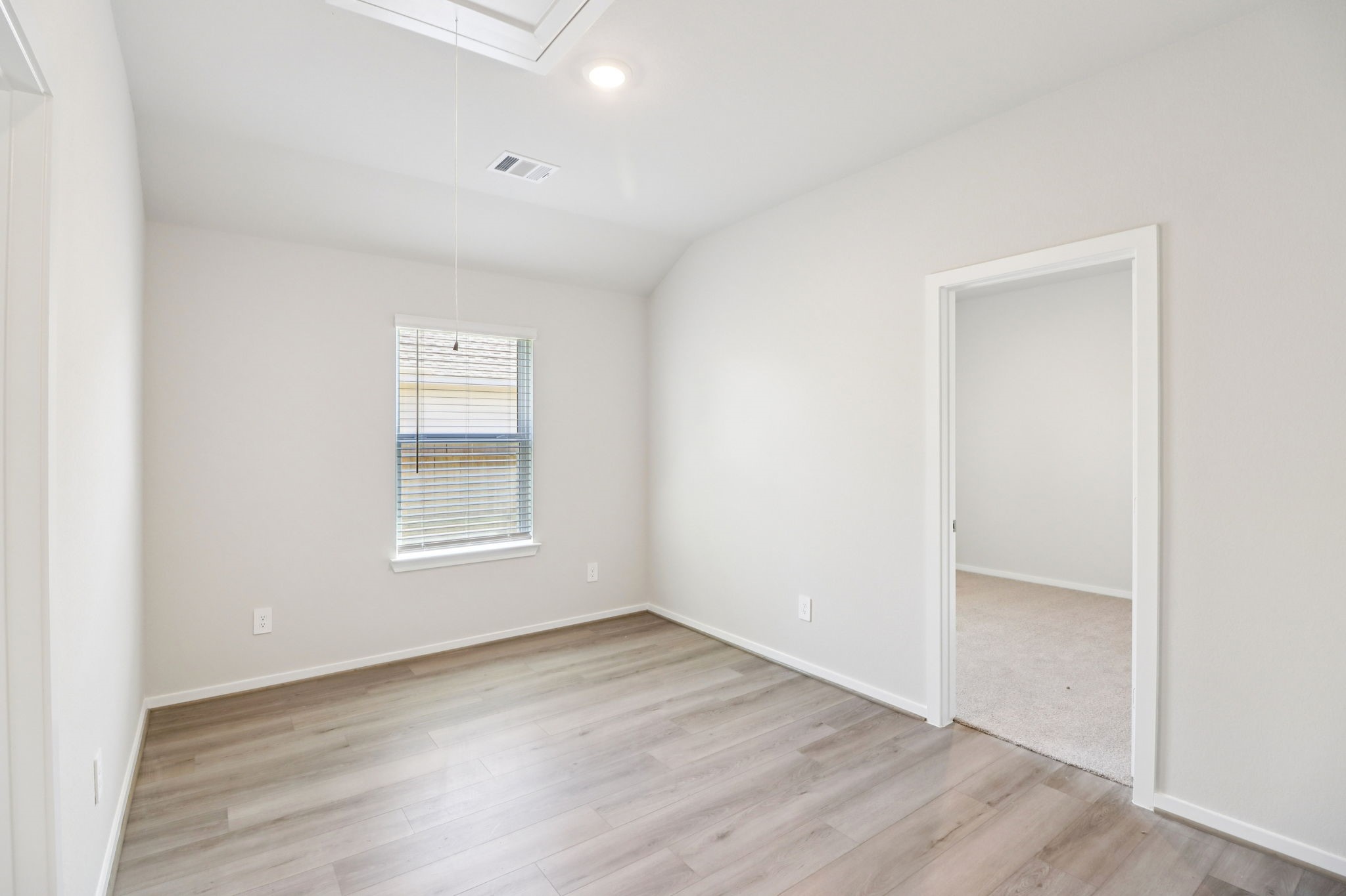 16273 Parish Pointe Court Conroe, TX 77302 - Photo 16 of 29 an empty room with wooden floor and windows
