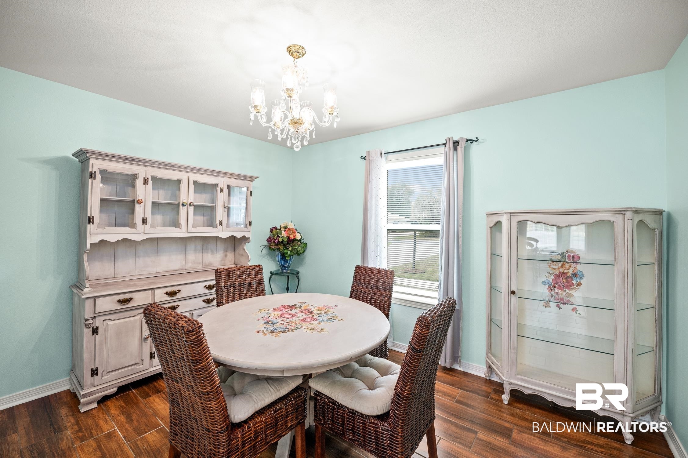 2553 Santa Rosa Drive Lillian, AL 36549 - Photo 12 of 51 Dining space with dark wood-style floors, baseboards, and an inviting chandelier