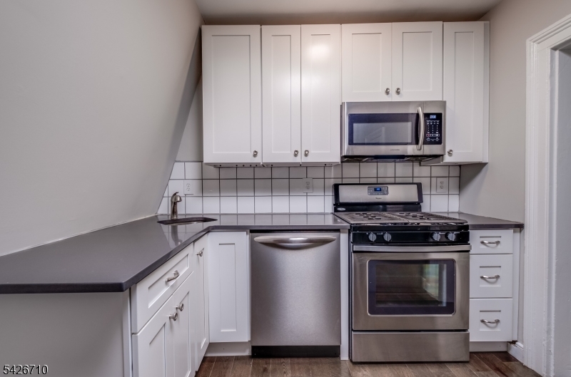 47 Ridgedale Avenue Morristown, NJ 07960 - Photo 13 of 14 a kitchen with stainless steel appliances a stove and white cabinets