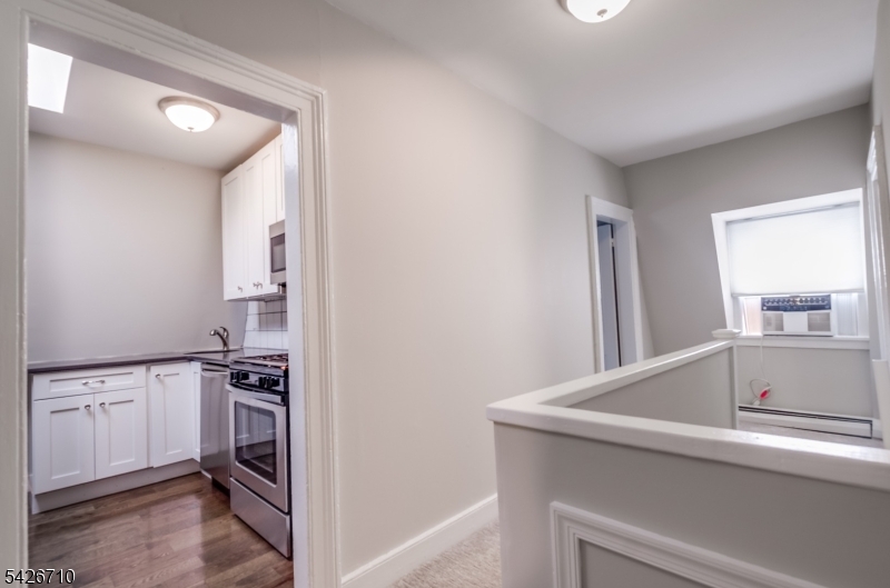 47 Ridgedale Avenue Morristown, NJ 07960 - Photo 5 of 14 a view of a kitchen with white cabinets and a stove top oven