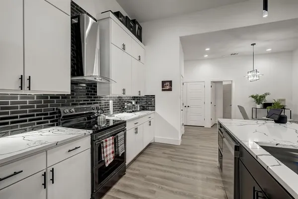 a kitchen with a sink stove and cabinets