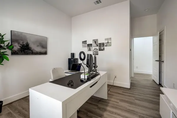 a kitchen with a stove and wooden floor