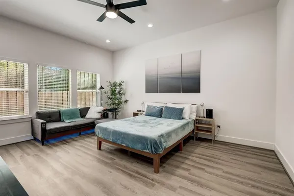 a spacious bedroom with a bed and a couch