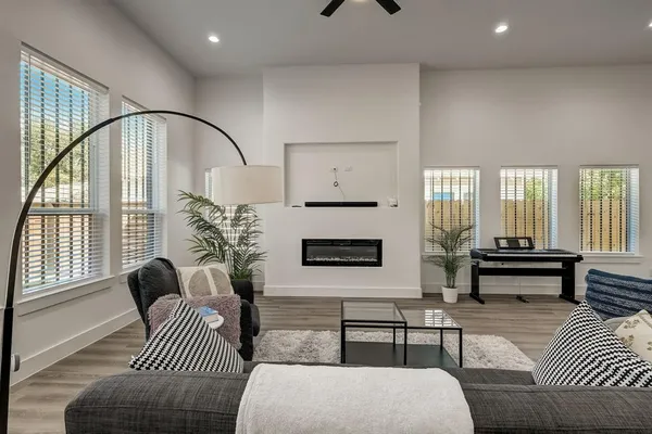 a living room with furniture and wooden floor