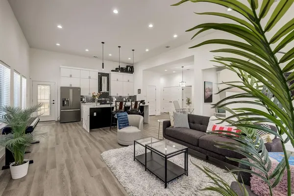 a living room with furniture flowerpot and flower pot