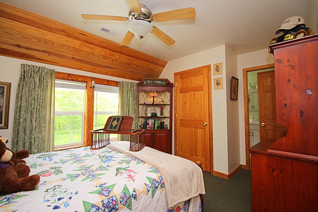2185 Loops Road Rainelle, WV 25962 - Photo 16 of 109 a bedroom with a bed a window and walk in closet